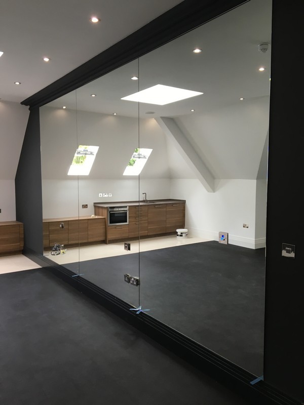 Frameless glass partition in loft conversion by Crystal Palace glaziers