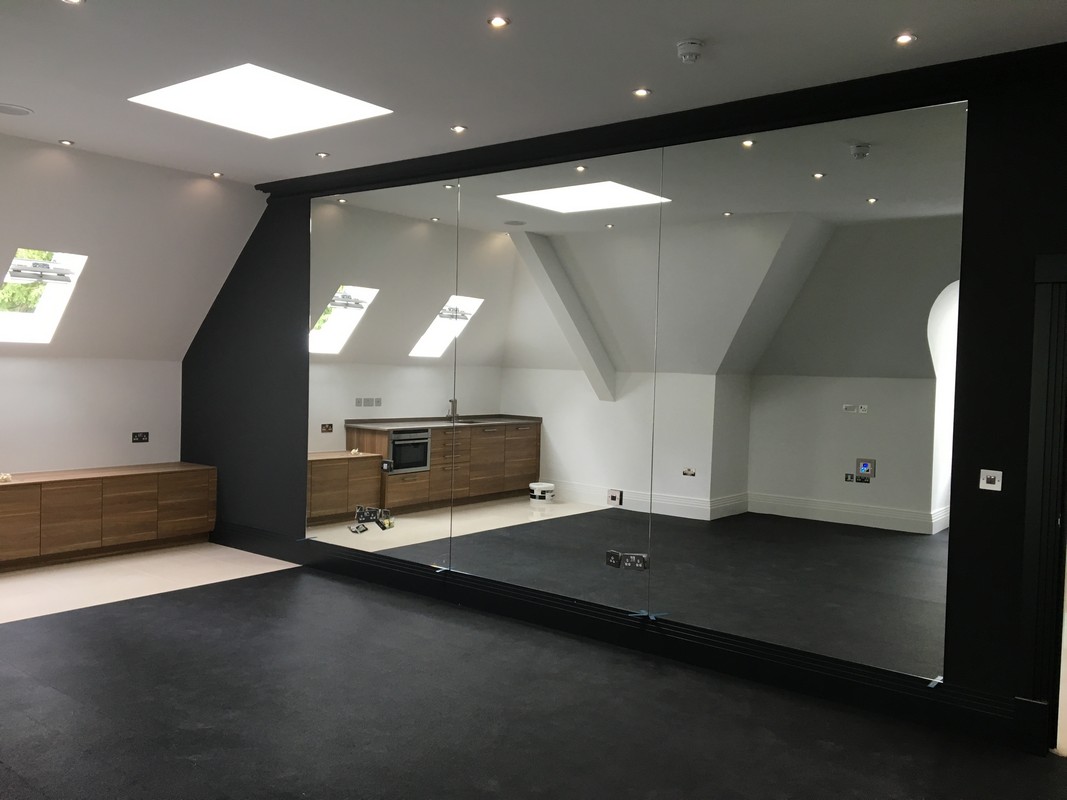 Frameless glass wall dividing loft conversion in Crystal Palace